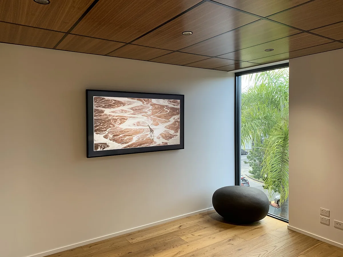 Finished living room with a timber ceiling, framed wall art and new power points